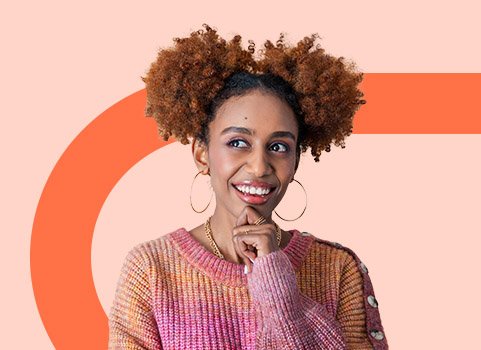 girl in pink and orange sweater pondering.