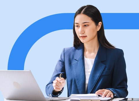 Women in blazer using laptop.