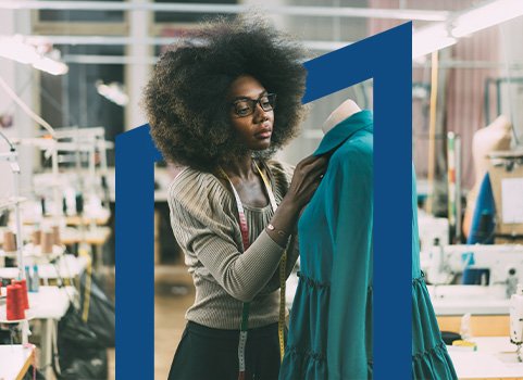 Woman designing dress using dress form.