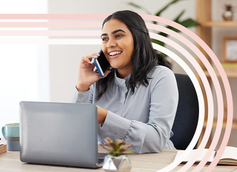 Woman on phone call in front of small laptop.