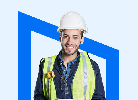 man in hard hat and vest wearing a big smile.