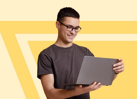 man with glasses smiling with laptop.