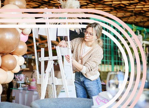 Woman setting up decor for wedding.