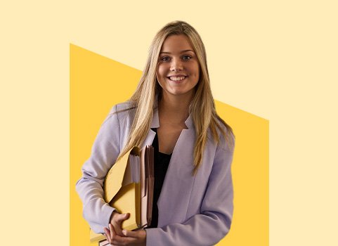 woman in blazer holding file folders.