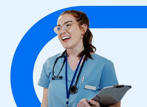 Medical Assistant in blue scrubs holding a clipboard.