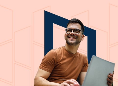 A man with medium brown skintone and dark hair, holding a laptop