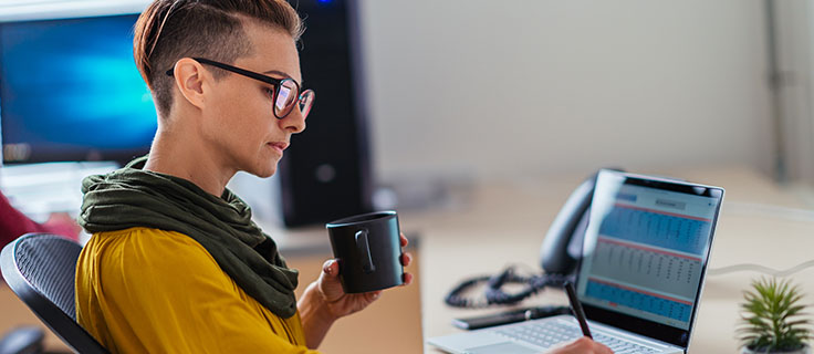 accountant taking notes at desk.