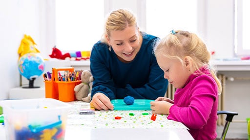 early childhood educator playing with student