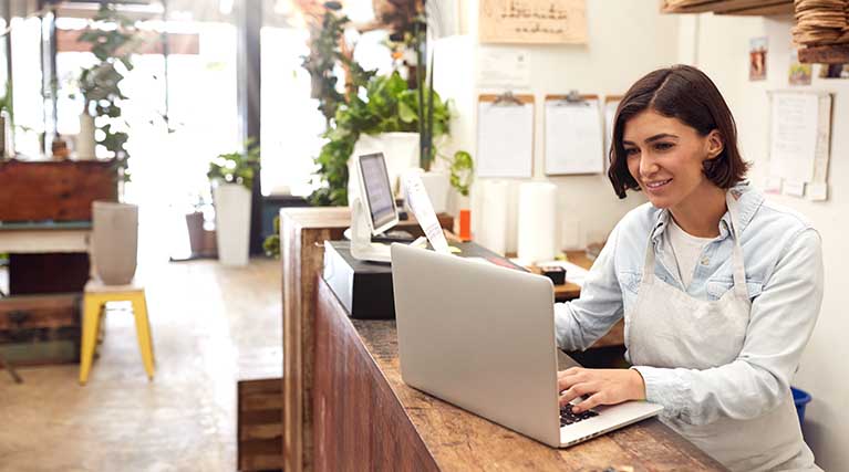 small business owner checking laptop.